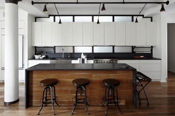 Modern white kitchen black slate countertop wooden flooring
