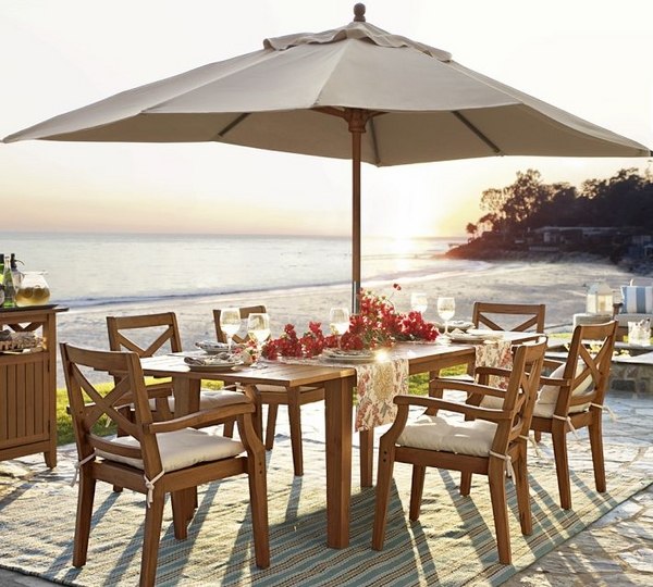 Wooden dining outdoors parasol carpet fresh flowers