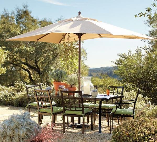 comfortable dining area in the garden metal chairs table parasol
