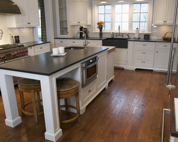 white kitchen slate island countetops wooden flooring