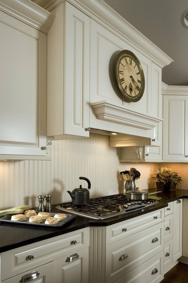 white kitchen cabinets dark countertop beadboard backsplash
