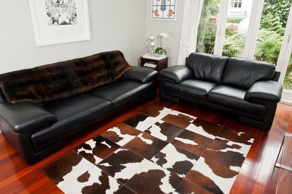 Cowhide patchwork rug chocolate brown and white black leather sofas