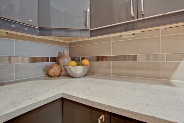 White-quartz countertop contemporary kitchen design beige backsplash