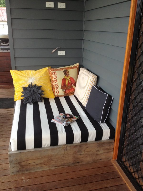 barn wood outdoor striped bedding decorative cushions veranda deck