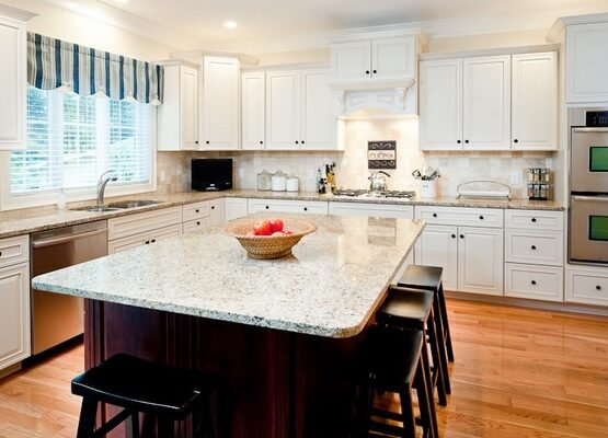 new-venetian-gold-granite-countertops-white-cabinets-dark-island-wood-flooring