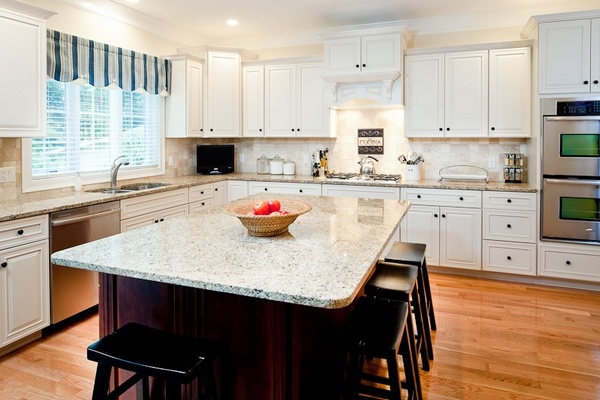 new-venetian-gold-granite-countertops-white-cabinets-dark-island-wood-flooring