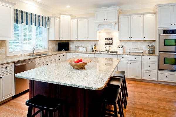 new venetian gold granite countertops white cabinets dark island wood flooring