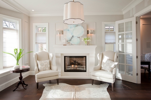 white cowhide living room decorating ideas white armchairs fireplace