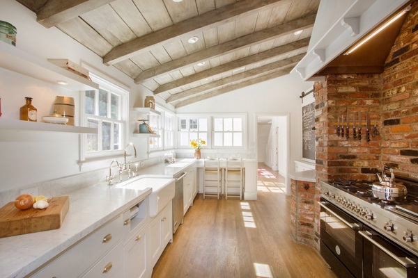white shaker cabinets exposed ceiling beams brick wall