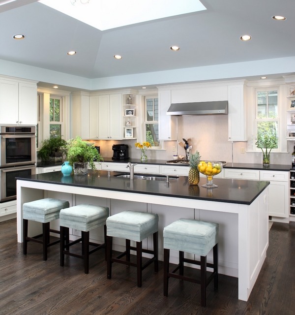 white kitchen black countertops blue bar stools