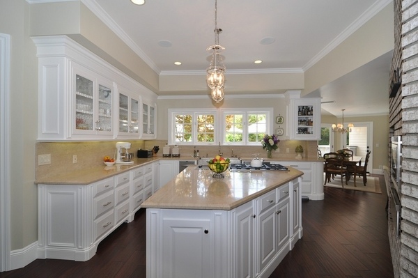 white-kitchen-cabinets-travertine-countertops-pendant-lights