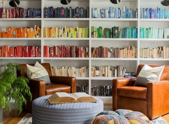 family-room-furniture-pouf-ottoman-armchairs-bookshelves