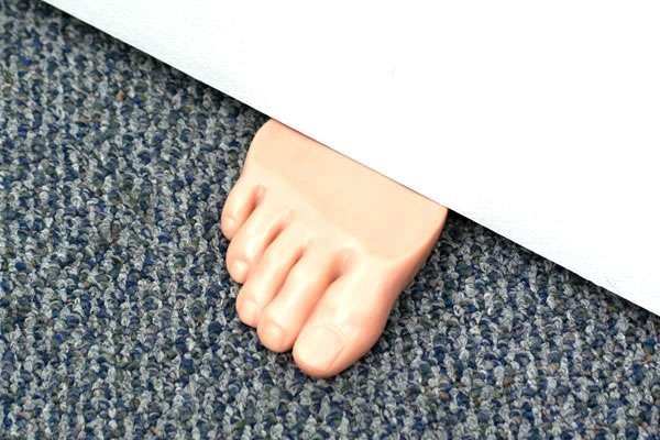 original funny foot in the door doorstop idea