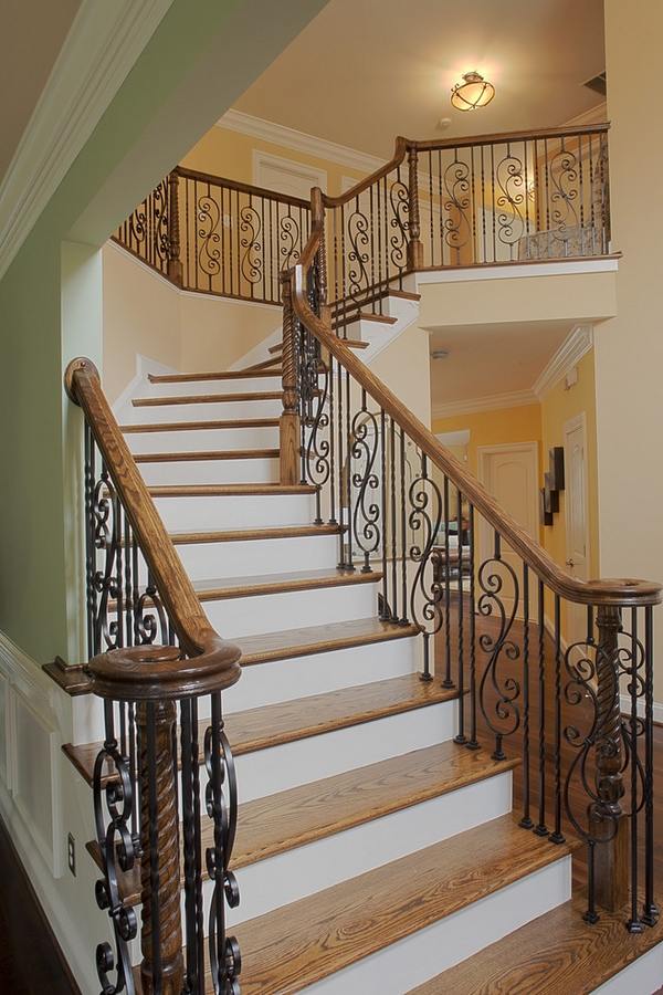 traditional staircase wrought iron railings wooden handrail