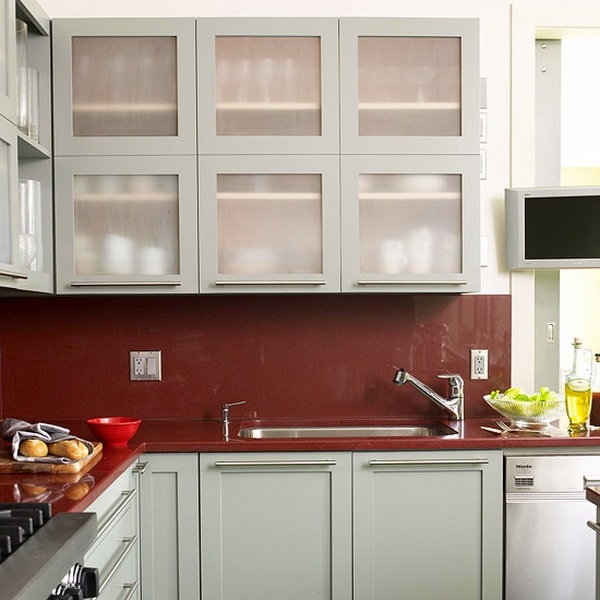 Glass backsplash red color white cabinets glass fronts