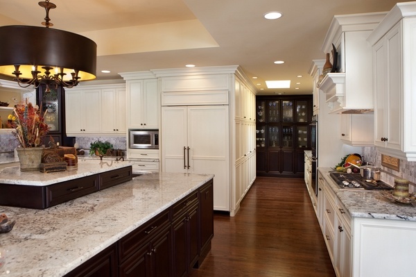 granite countertop dark wood kitchen island white cabinets