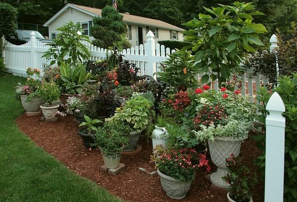 container gardening ideas planters flower pots picket fence
