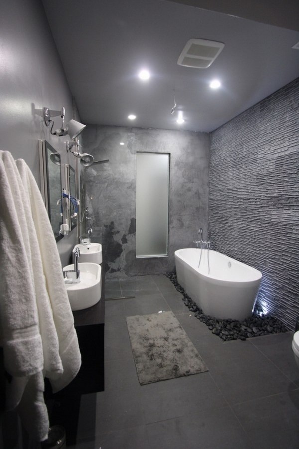 trendy gray bathroom tiles black pebble stones bathtub