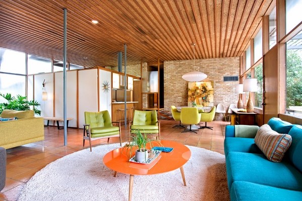 Mid-century-modern-style-family room bold colors blue sofa orange coffee table