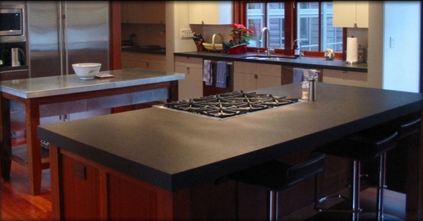 Matte black poured concrete countertops kitchen desing kitchen island with cooktop