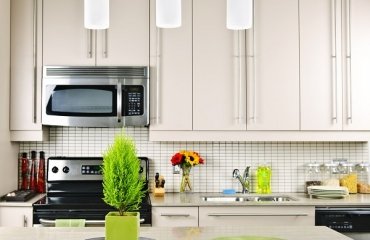 beautiful-kitchen-white-cabinets-tile-backsplash-limestone-countertop-pendant-lamps