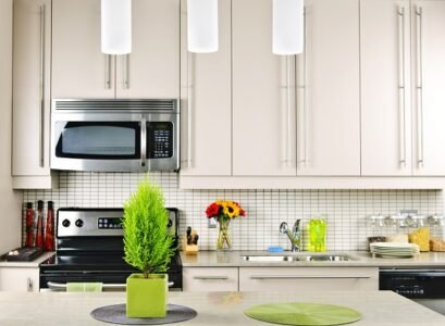 beautiful-kitchen-white-cabinets-tile-backsplash-limestone-countertop-pendant-lamps