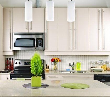 beautiful-kitchen-white-cabinets-tile-backsplash-limestone-countertop-pendant-lamps