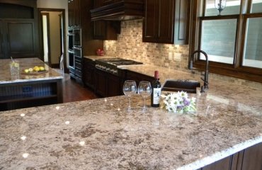 bianco-antico-granite-countertops-dark-wood-kitchen-cabinets-luxury-kitchen-countertops