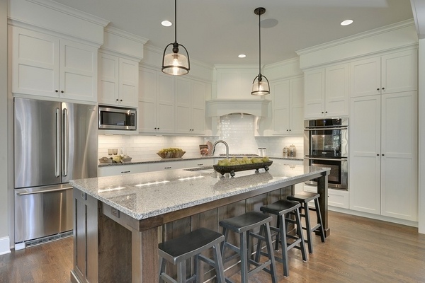 contemporary-kitchens-new-caledonia-granite-countertops-white-cabinetry-wood-flooring