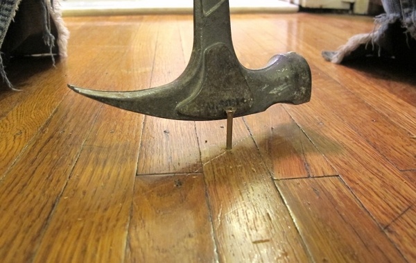 how to fix squeaky floors DIY home repait hammering nails
