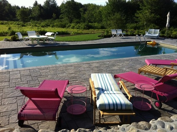 outdoor swimming pool patio design concrete flooring sunbeds