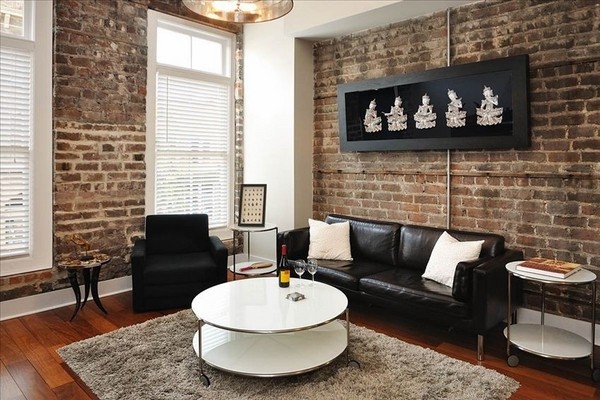 Chic-loft-apartment-design-living-room-interior-ideas-brick-walls-black-leather-sofa-white-coffee-table