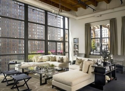 Elegant-living-room-chic-loft-apartment-large-sofa-set-glass-coffee-table-exposed-ceiling-beams