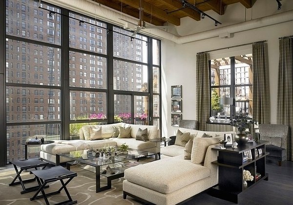 Elegant living room chic loft apartment large sofa set glass coffee table exposed ceiling beams