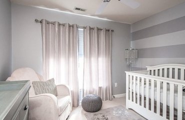Elegant-small-nursery-design-white-gray-colors-wall-stripes-baby-cot-armchair-changing-table