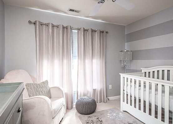 Elegant-small-nursery-design-white-gray-colors-wall-stripes-baby-cot-armchair-changing-table