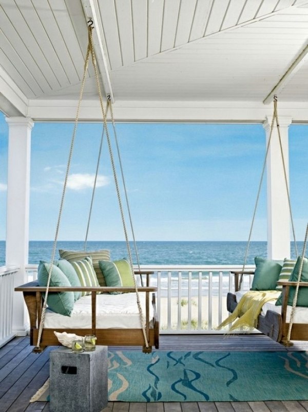 beach house porch wood swings decorative pillows carpet
