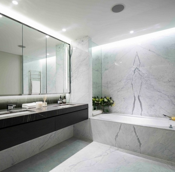 floating bathroom vanity cabinet indirect overhead lighting marble tiles