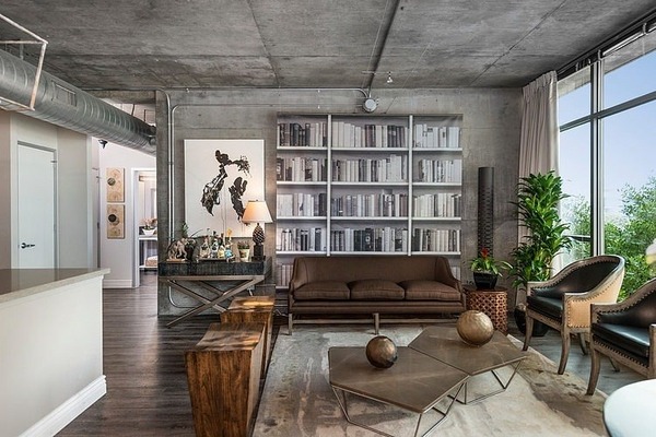 loft-style-apartment-wood-elements-rustic-coffee-table-leather-chair-wall-bookcase