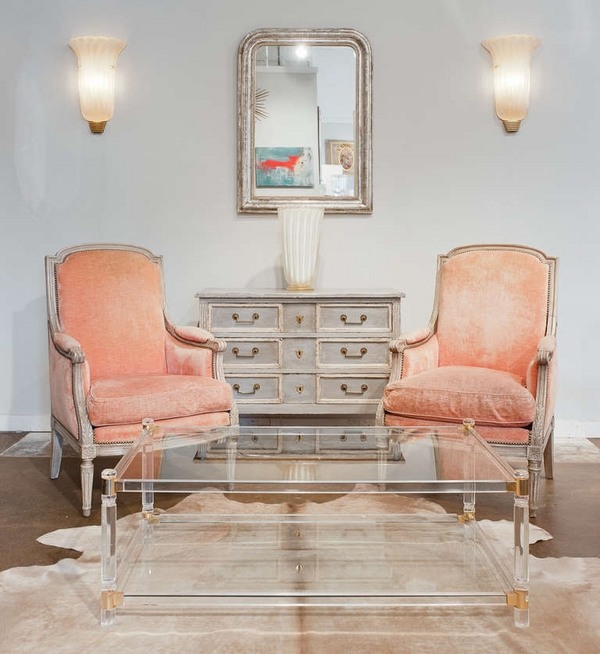 Acrylic table cowhide rug elegant armchairs wall mirror