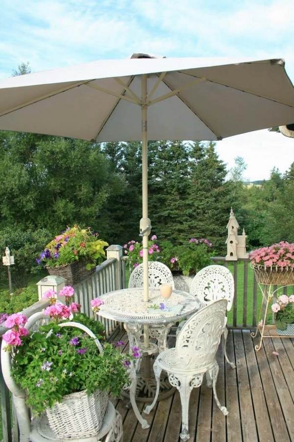 romantic balcony white furniture parasol flowers