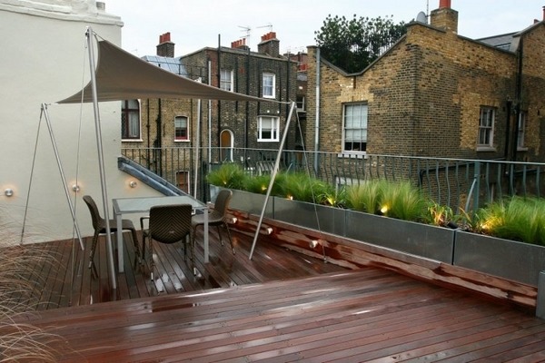 rooftop balcony wood flooring metal planters awning outdoor furniture