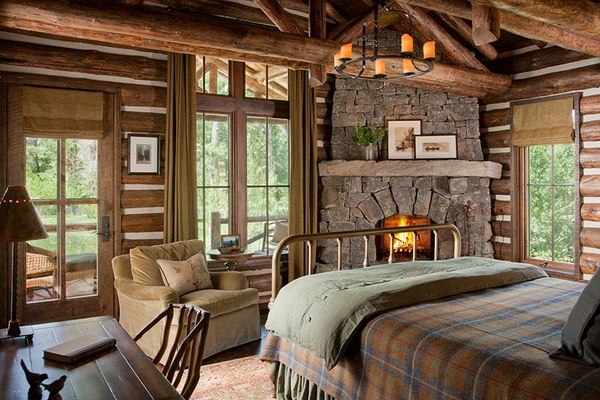 rustic decor stone fireplace iron bed ceiling beams