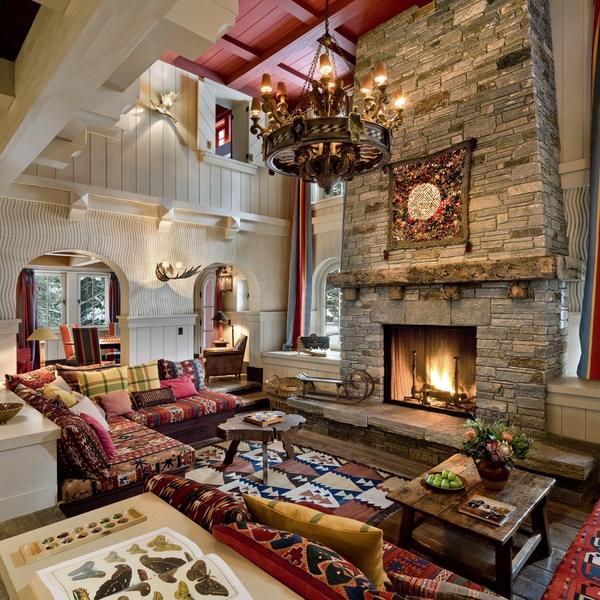 living room design stone fireplace wooden mantle chandelier
