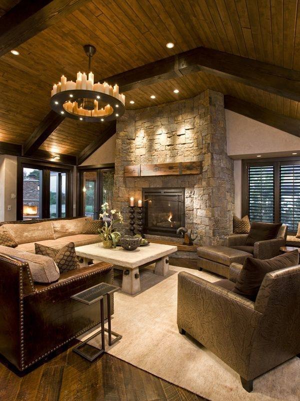 rustic interior design neutral colors beige area rug sofa armchairs stone fireplace