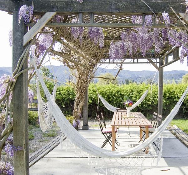 Backyard escapes ideas wooden pergola hammocks wooden table