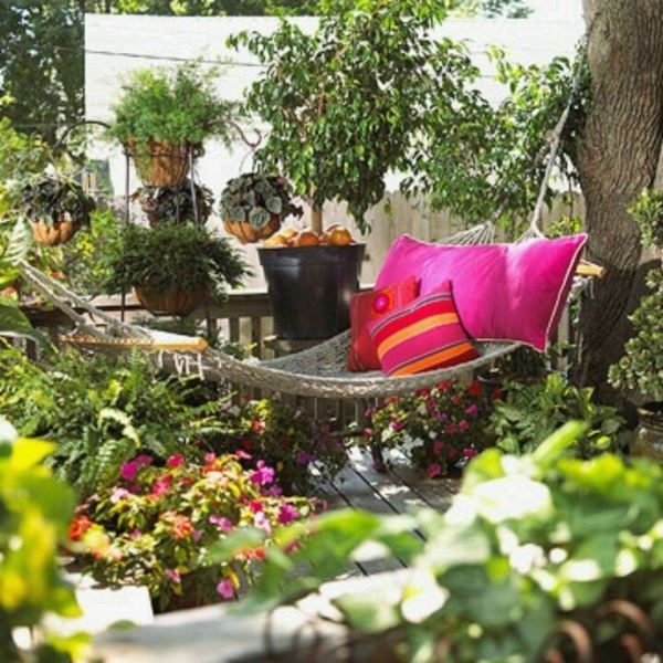 backyard escapes ideas hammock colorful pillows flower pots