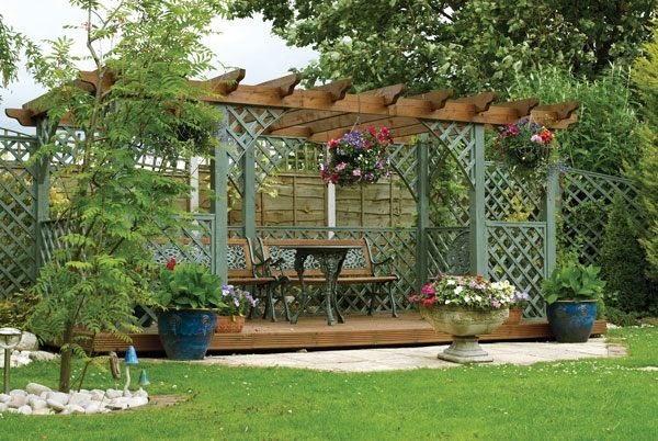 backyard retreat pergola lattice garden bench round table