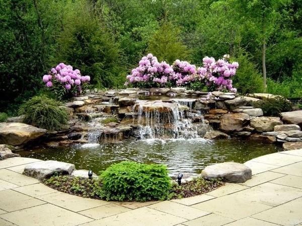 patio design oasis waterfall pink flowers trees