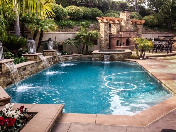 pool with waterfalls modern patio palm trees pergola fireplace